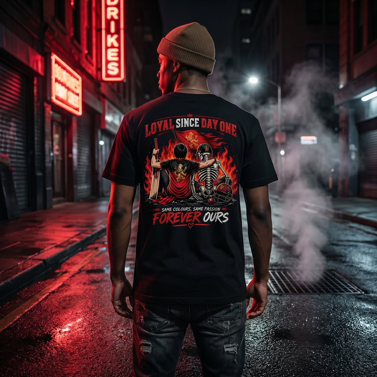 Male model in King Kohli Loyal Since Day One black oversized t-shirt back view on dark rainy urban street at night, cinematic moody cricket fan lifestyle photography