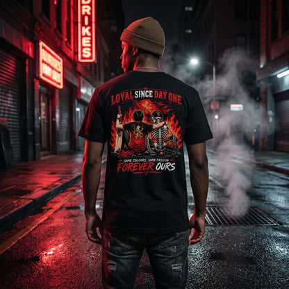 Male model in King Kohli Loyal Since Day One black oversized t-shirt back view on dark rainy urban street at night, cinematic moody cricket fan lifestyle photography