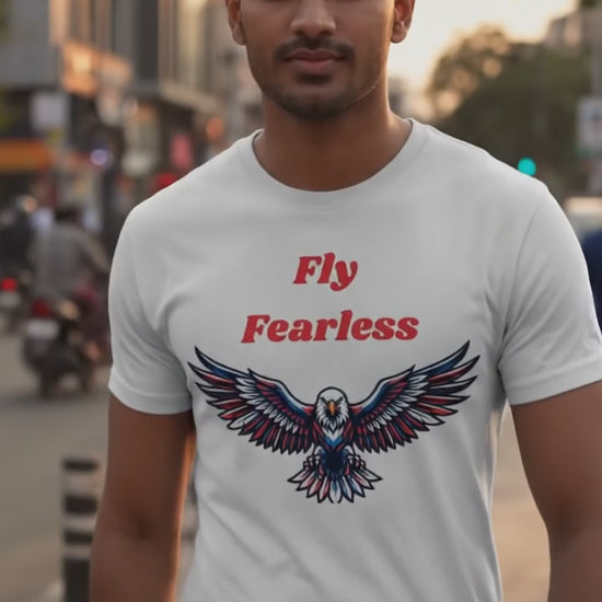 Indian male model wearing Fly Fearless white graphic t-shirt with eagle print outdoors on urban street, casual lifestyle fashion videography